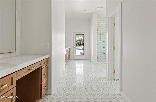 10755 E Cholla Ln, Scottsdale, AZ 85259 - bathroom featuring vanity, baseboards, a tile shower, and tile patterned floors