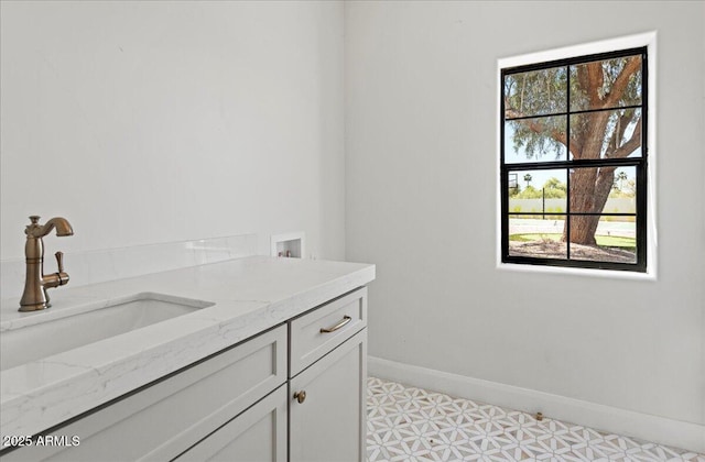 10755 E Cholla Ln, Scottsdale, AZ 85259 - bathroom with healthy amount of natural light, baseboards, vanity, and tile patterned floors