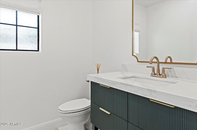 10755 E Cholla Ln, Scottsdale, AZ 85259 - half bath featuring vanity, baseboards, and toilet