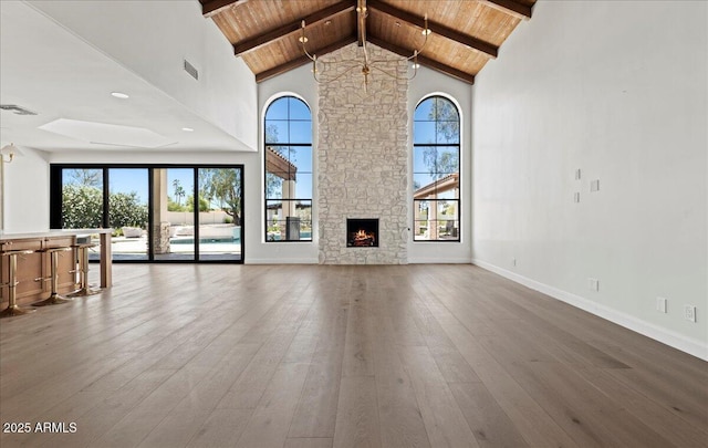 10755 E Cholla Ln, Scottsdale, AZ 85259 - unfurnished living room with wooden ceiling, healthy amount of natural light, hardwood / wood-style floors, high vaulted ceiling, and beamed ceiling