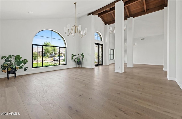 10755 E Cholla Ln, Scottsdale, AZ 85259 - unfurnished dining area featuring a chandelier, beamed ceiling, light wood-style flooring, baseboards, and high vaulted ceiling