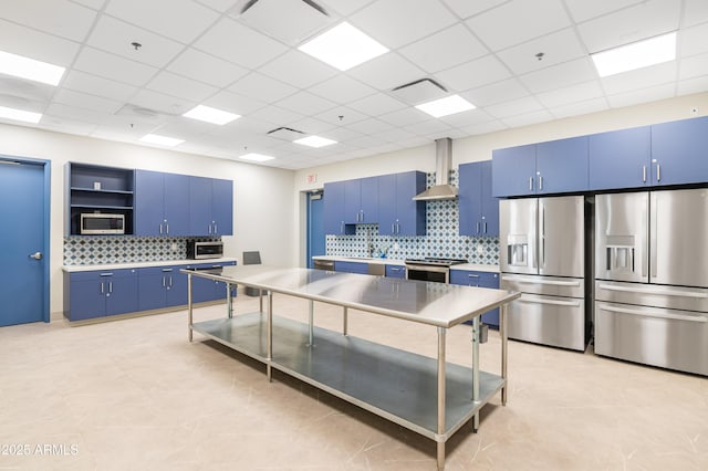 12039 E Primrose Ln, Florence, AZ 85132 - kitchen featuring blue cabinetry, stainless steel appliances, wall chimney range hood, open shelves, and tasteful backsplash
