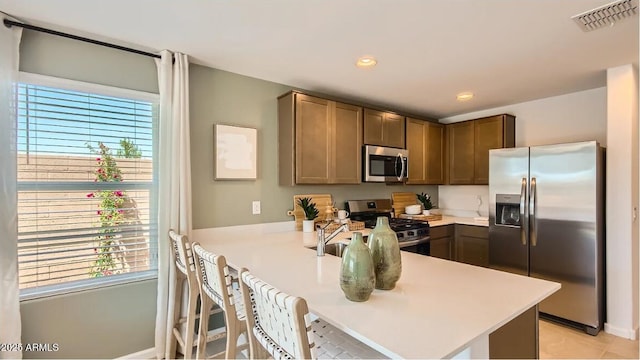 12039 E Primrose Ln, Florence, AZ 85132 - kitchen with stainless steel appliances, plenty of natural light, a peninsula, light countertops, and recessed lighting