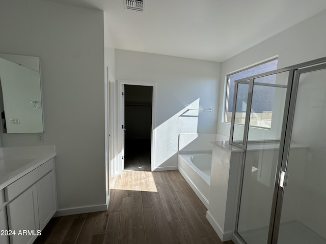 bathroom with vanity, shower with separate bathtub, and hardwood / wood-style flooring