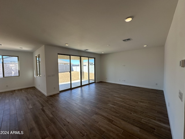 spare room with dark wood-type flooring