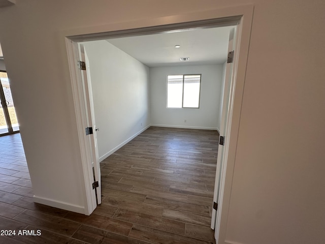 spare room with dark wood-type flooring