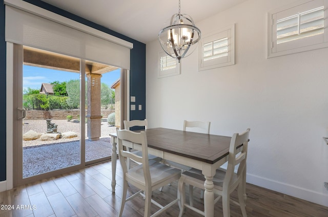 dining room with plenty of natural light, a chandelier, and wood-type flooring