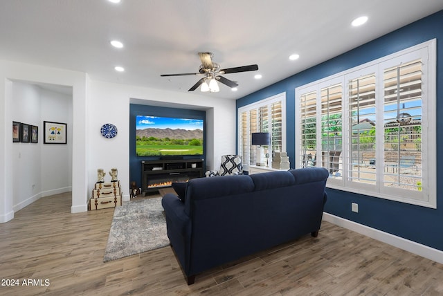 living room featuring hardwood / wood-style flooring, ceiling fan, and a healthy amount of sunlight