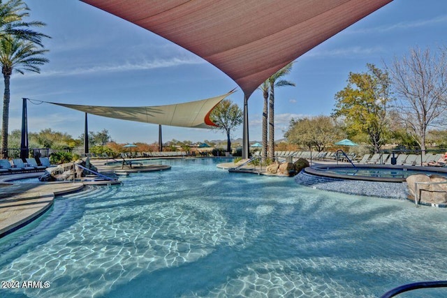 view of pool with a patio and a hot tub