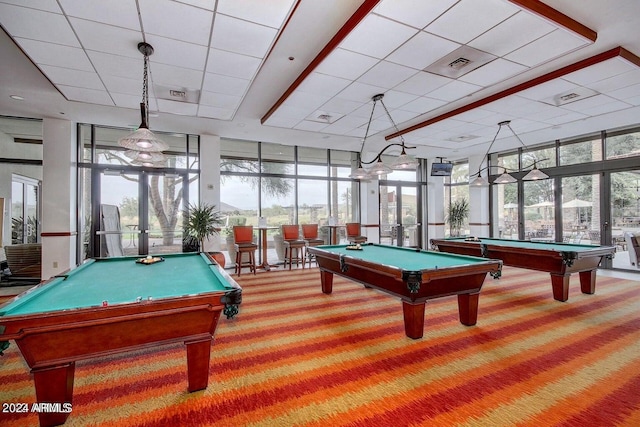 recreation room featuring carpet flooring, a wealth of natural light, french doors, and expansive windows