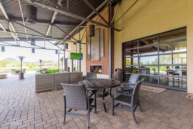 view of patio featuring an outdoor living space with a fireplace