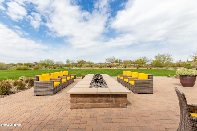 view of patio with an outdoor living space with a fire pit