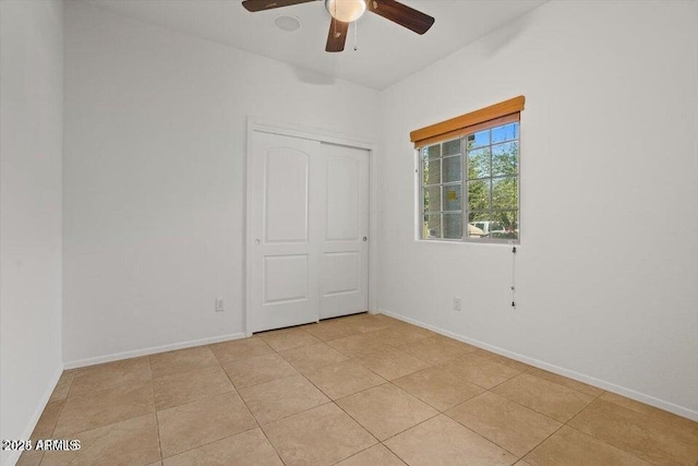 unfurnished room featuring ceiling fan and light tile patterned flooring