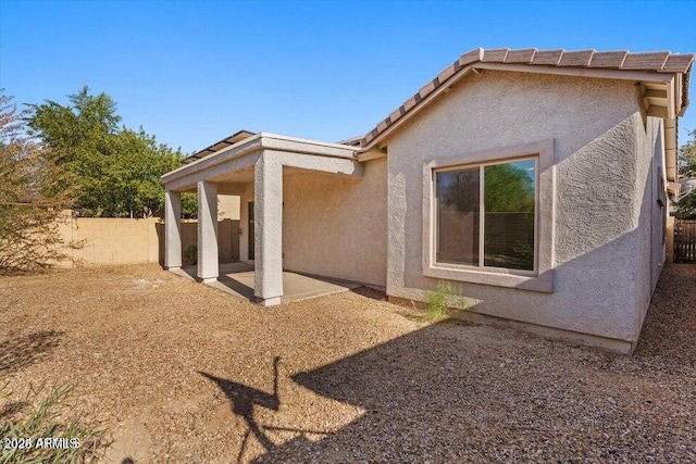 back of property with a patio