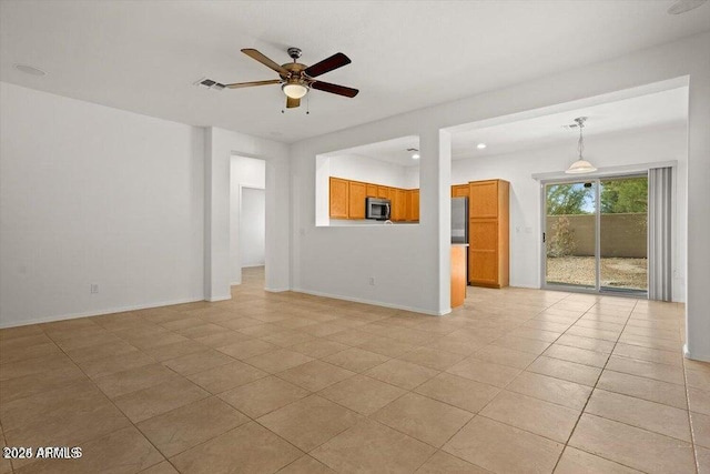 unfurnished living room with ceiling fan and light tile patterned floors