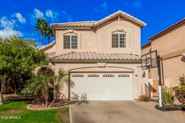 mediterranean / spanish house with a tiled roof, stucco siding, driveway, and a garage