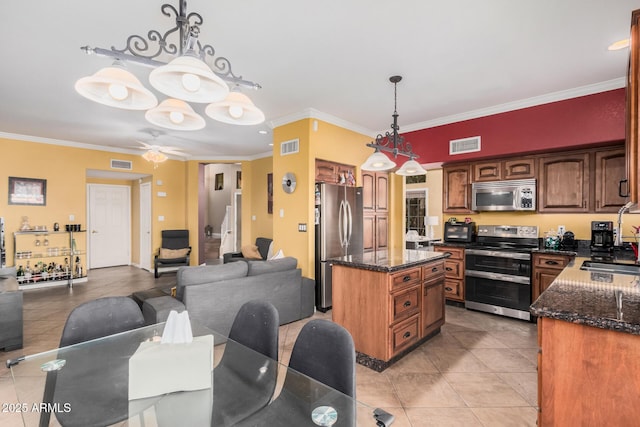 kitchen with visible vents, appliances with stainless steel finishes, open floor plan, and a sink