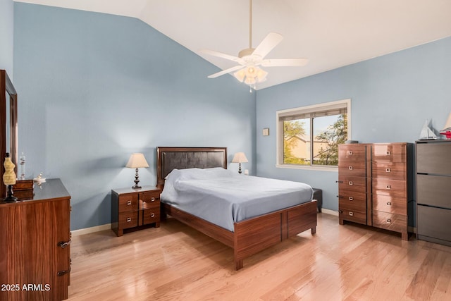 bedroom featuring light wood-type flooring, baseboards, ceiling fan, and vaulted ceiling