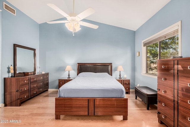 bedroom with lofted ceiling, light wood-style flooring, baseboards, and visible vents