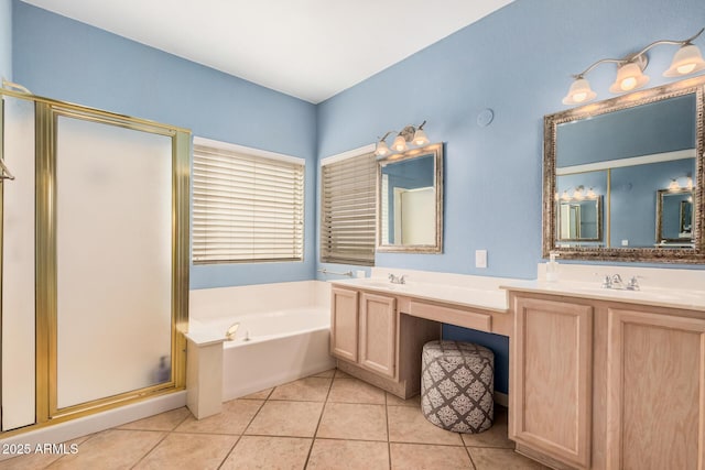 bathroom with tile patterned floors, a garden tub, a stall shower, a sink, and double vanity