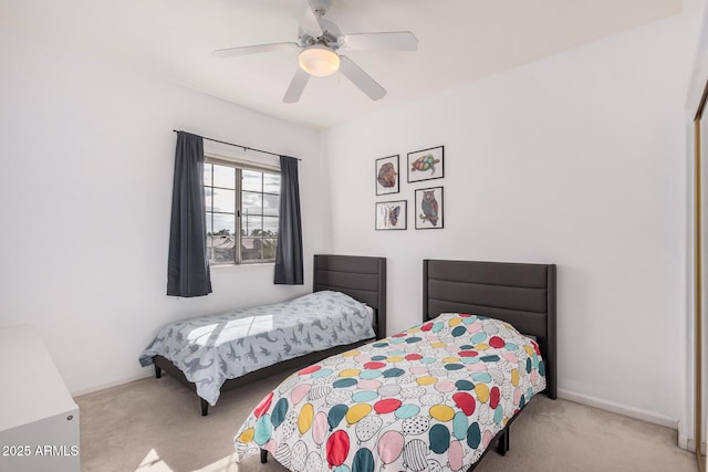 carpeted bedroom with baseboards and a ceiling fan