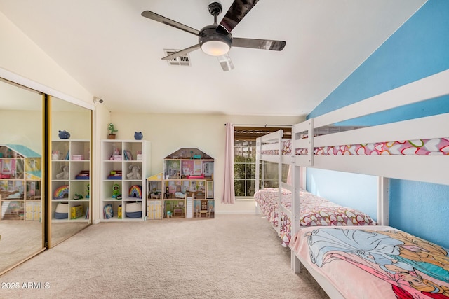 carpeted bedroom featuring vaulted ceiling, a ceiling fan, visible vents, and a closet