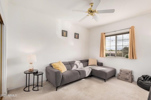 carpeted living room with baseboards and ceiling fan