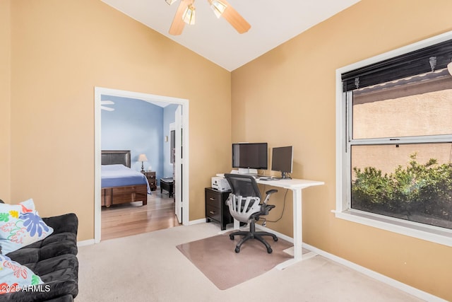 office area featuring baseboards, carpet, ceiling fan, and vaulted ceiling