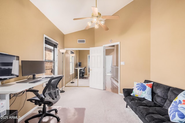 office featuring visible vents, light colored carpet, high vaulted ceiling, and a ceiling fan