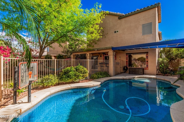 view of pool with a fenced in pool and fence