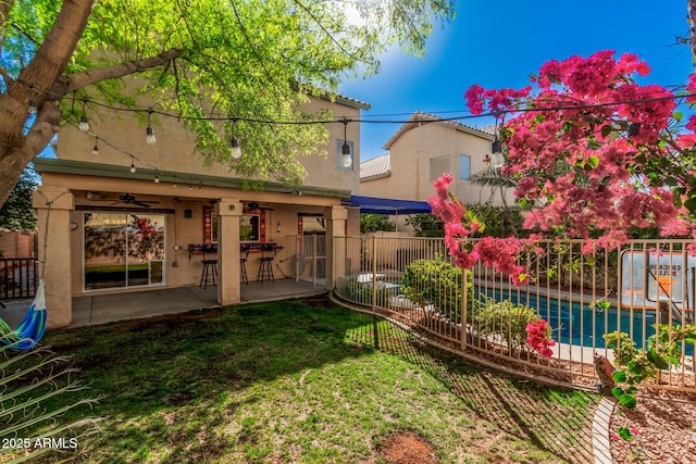 view of yard featuring a patio area, a ceiling fan, and fence