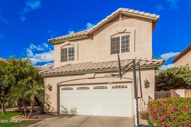 mediterranean / spanish home featuring a tiled roof, a garage, driveway, and stucco siding