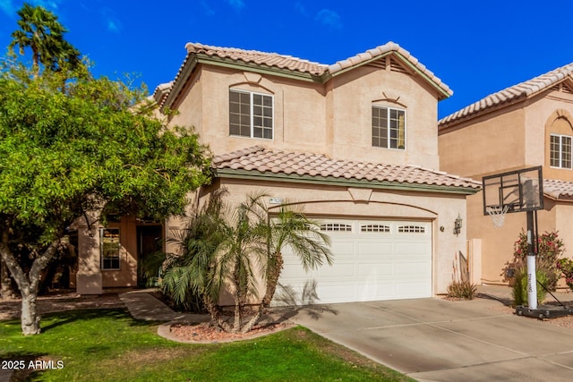 mediterranean / spanish home with a tiled roof, stucco siding, an attached garage, and concrete driveway