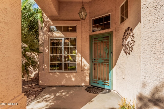 property entrance with stucco siding