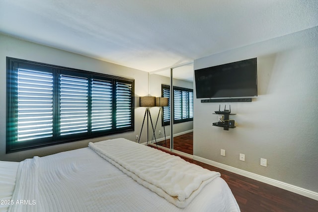 5122 E Shea Blvd Unit 1020, Scottsdale, AZ 85254 - bedroom with a closet, baseboards, and wood finished floors