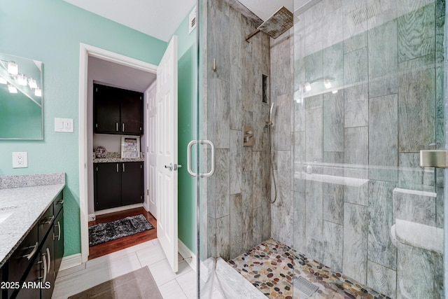 5122 E Shea Blvd Unit 1020, Scottsdale, AZ 85254 - bathroom with vanity, baseboards, visible vents, a stall shower, and tile patterned floors