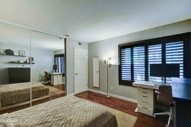 5122 E Shea Blvd Unit 1020, Scottsdale, AZ 85254 - bedroom featuring visible vents, baseboards, a textured ceiling, and dark wood-style flooring