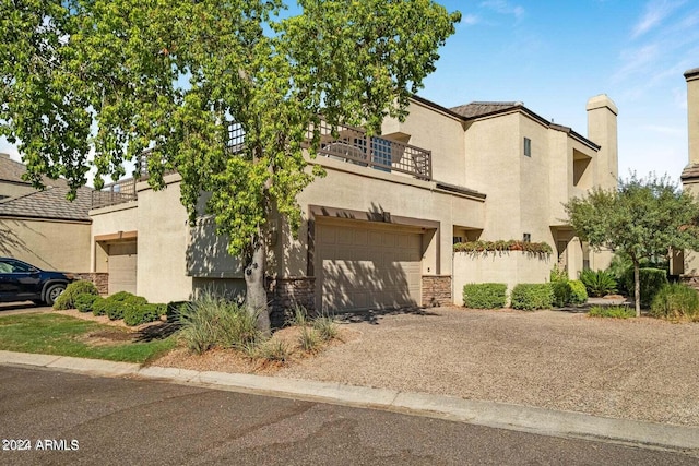 mediterranean / spanish-style home featuring a balcony and a garage