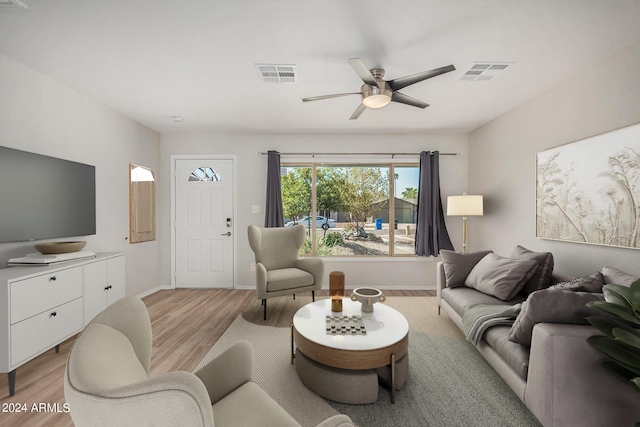 living room featuring ceiling fan and light wood-type flooring