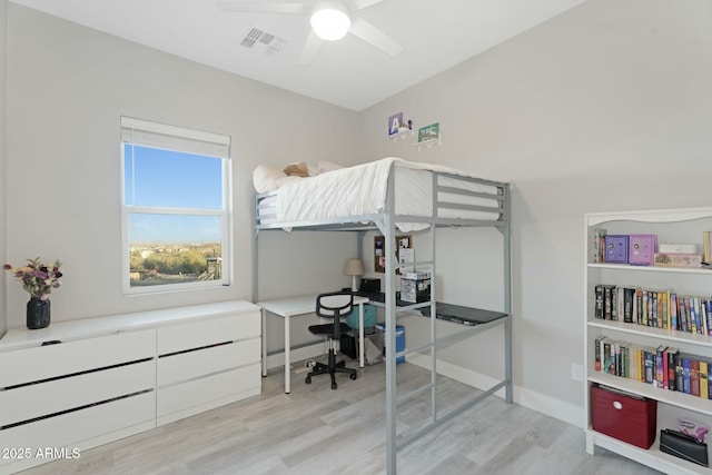 bedroom featuring a ceiling fan, baseboards, visible vents, and wood finished floors