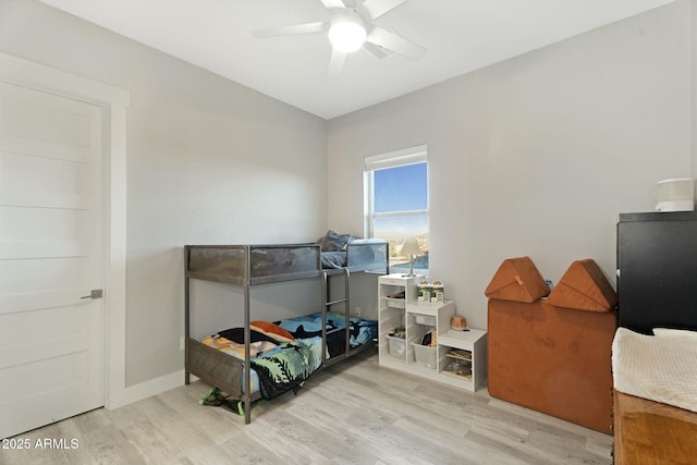 bedroom with lofted ceiling, a ceiling fan, baseboards, and wood finished floors