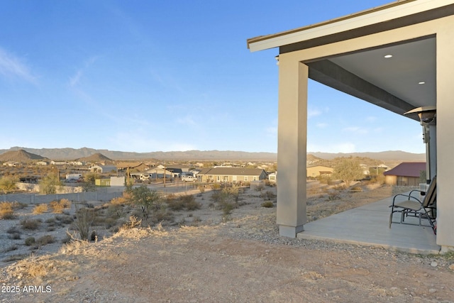 view of yard with a mountain view and a patio