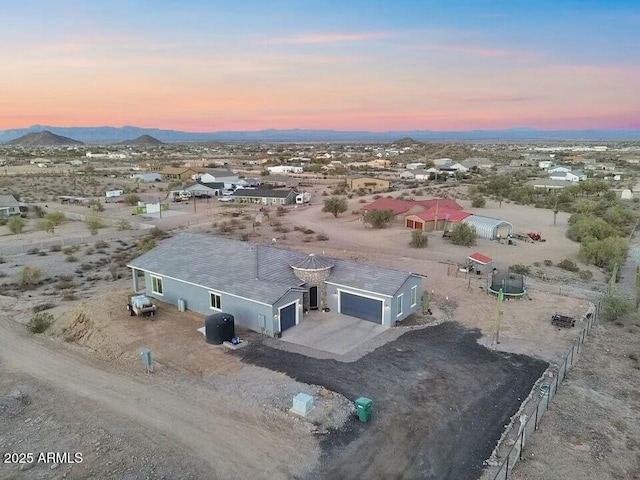 aerial view at dusk featuring a mountain view