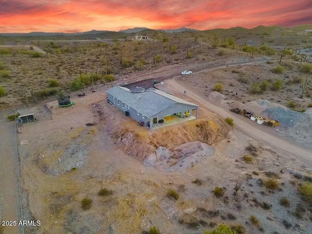 aerial view at dusk with a desert view and a mountain view