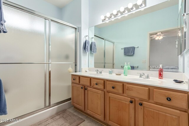 bathroom featuring tile patterned flooring, vanity, ceiling fan, and an enclosed shower