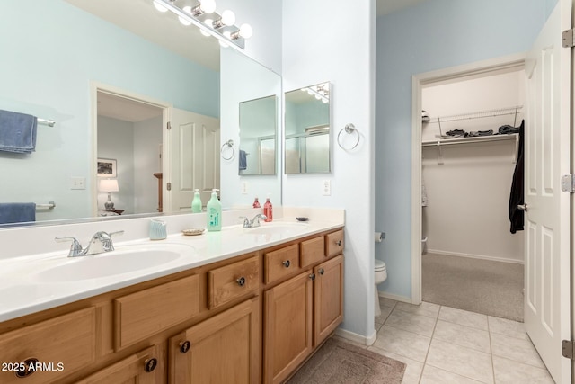 bathroom featuring tile patterned floors, vanity, and toilet