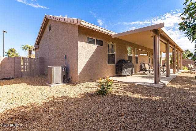 back of house with a patio area and central AC unit