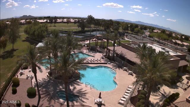 view of swimming pool with a mountain view and a patio