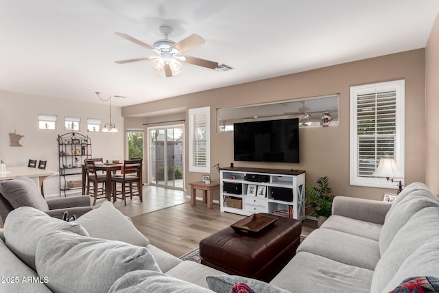 living room featuring light hardwood / wood-style flooring and ceiling fan