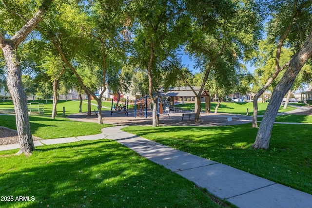 view of home's community featuring a playground and a yard